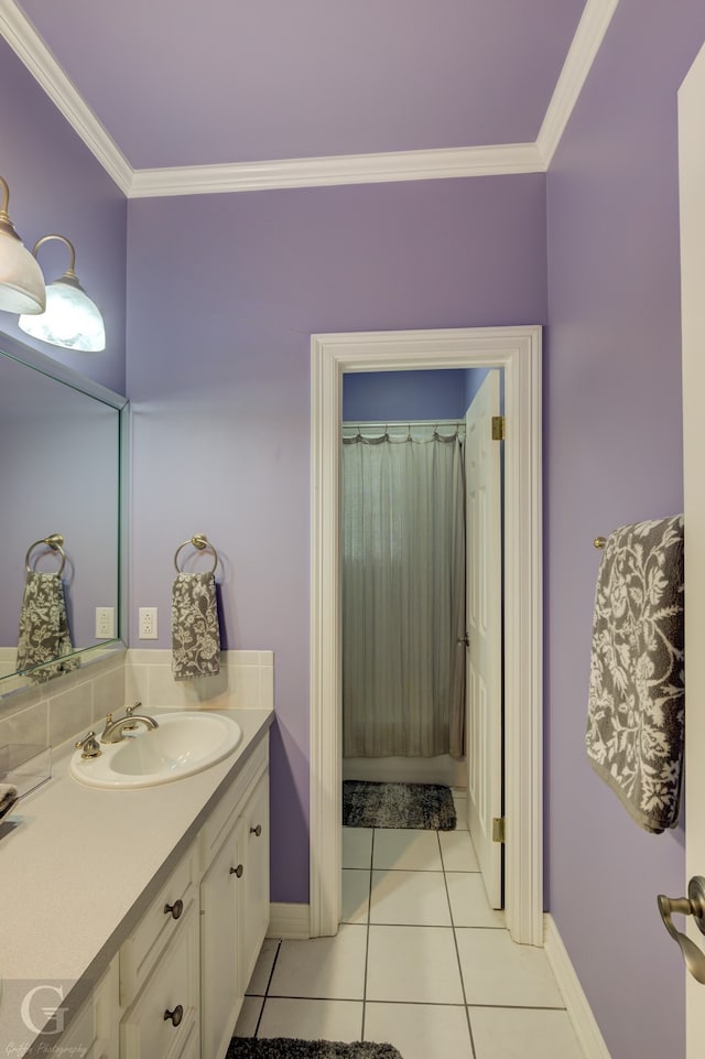 bathroom with crown molding, vanity, and tile patterned floors