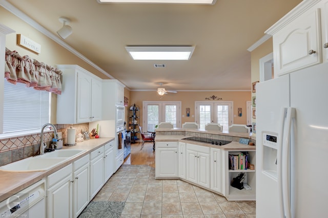 kitchen with white cabinetry, white appliances, french doors, ornamental molding, and sink