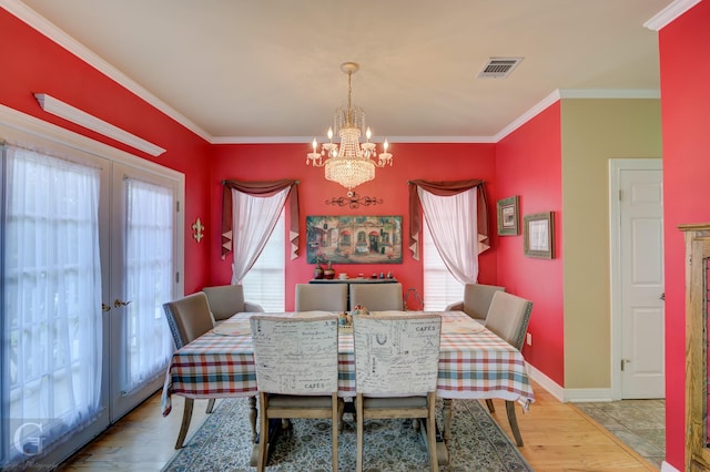5725 S Lakeshore Dr, Shreveport, LA 71119 - dining room with an inviting chandelier, ornamental molding, french doors, visible vents, and wood finished floors