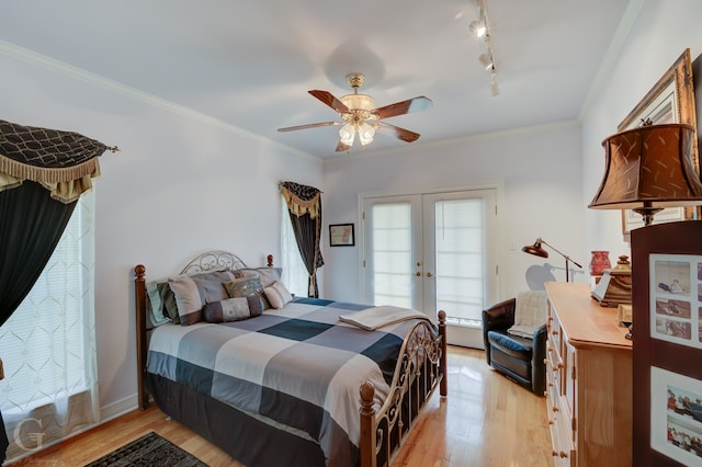 bedroom featuring ceiling fan, french doors, light hardwood / wood-style flooring, track lighting, and crown molding