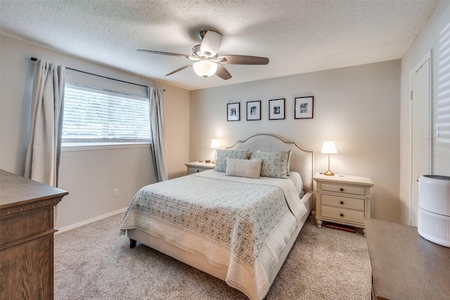 carpeted bedroom with a textured ceiling and ceiling fan