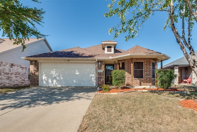 view of front facade with a garage and a front yard