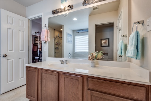 bathroom featuring walk in shower and vanity