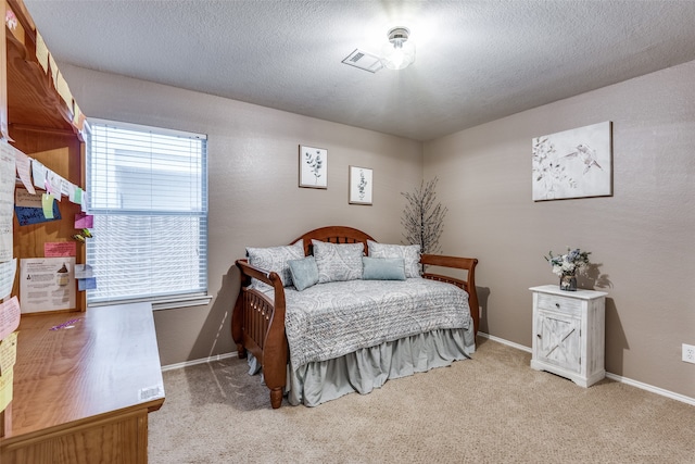 carpeted bedroom with a textured ceiling