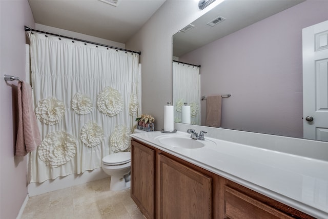 bathroom with curtained shower, vanity, and toilet