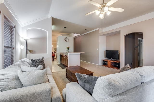 carpeted living room featuring lofted ceiling, ornamental molding, sink, and ceiling fan