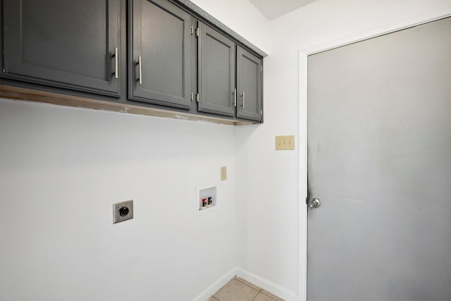 washroom featuring cabinets, hookup for an electric dryer, hookup for a washing machine, and light tile patterned floors