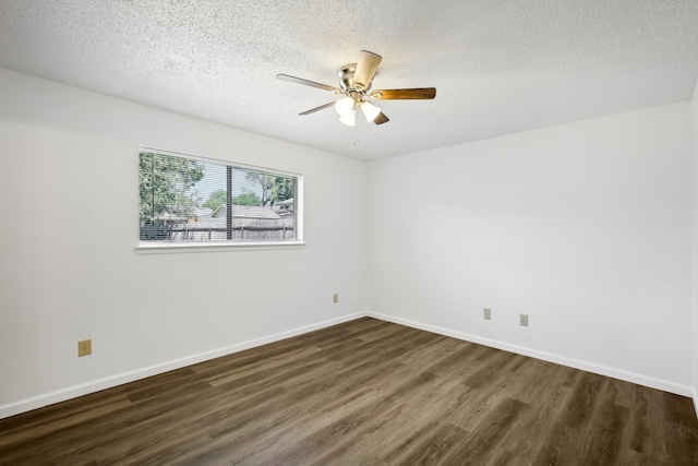 empty room featuring a textured ceiling, dark wood-type flooring, and ceiling fan