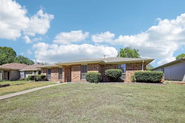 ranch-style home featuring a front yard