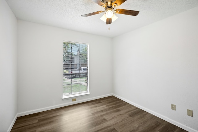 empty room featuring a textured ceiling, dark hardwood / wood-style flooring, and ceiling fan