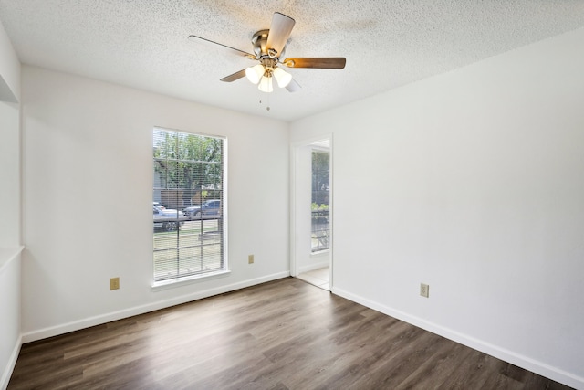 unfurnished room featuring a textured ceiling, dark hardwood / wood-style floors, and ceiling fan