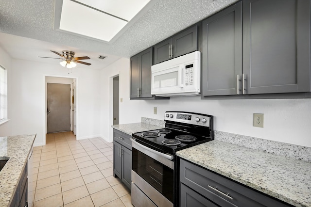 kitchen featuring stainless steel range with electric cooktop, a textured ceiling, light stone countertops, and ceiling fan