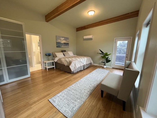 bedroom featuring lofted ceiling with beams, a wall mounted AC, and hardwood / wood-style flooring