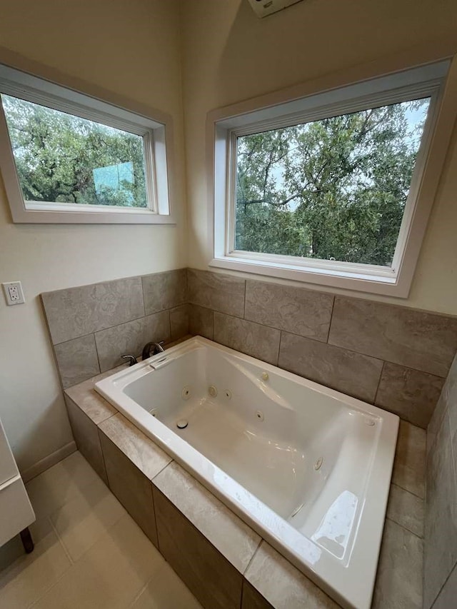 bathroom with tiled bath and tile patterned floors