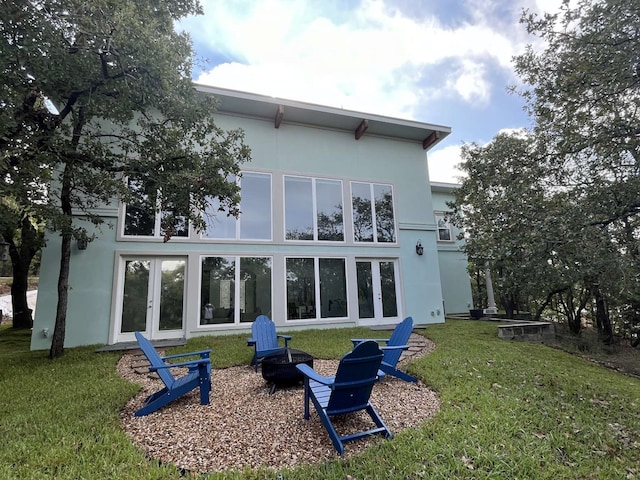 rear view of house featuring a yard