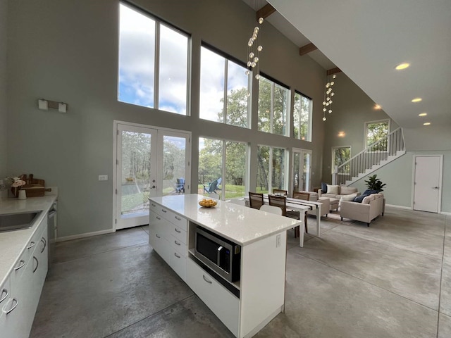 interior space with a high ceiling and concrete floors