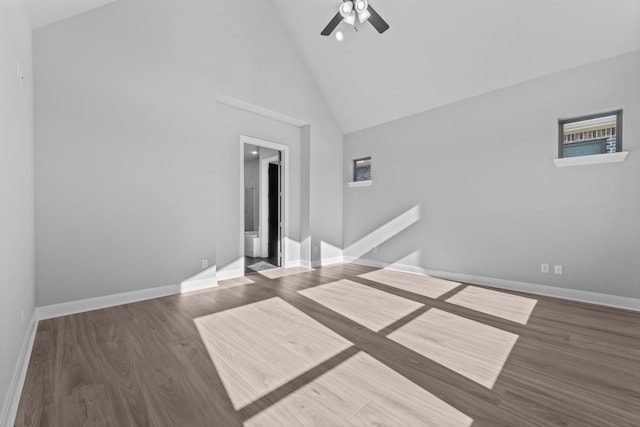 empty room featuring ceiling fan, high vaulted ceiling, and dark hardwood / wood-style floors