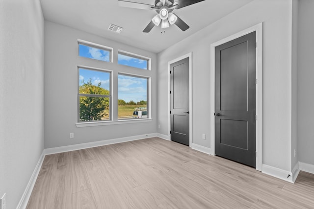 unfurnished bedroom with ceiling fan and light wood-type flooring