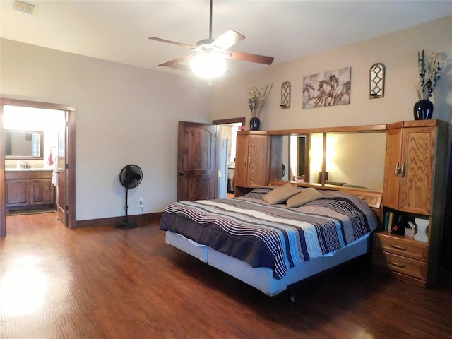 bedroom with ensuite bath, ceiling fan, and dark hardwood / wood-style flooring