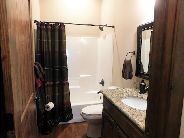 full bathroom with shower / bath combination with curtain, hardwood / wood-style floors, vanity, and toilet