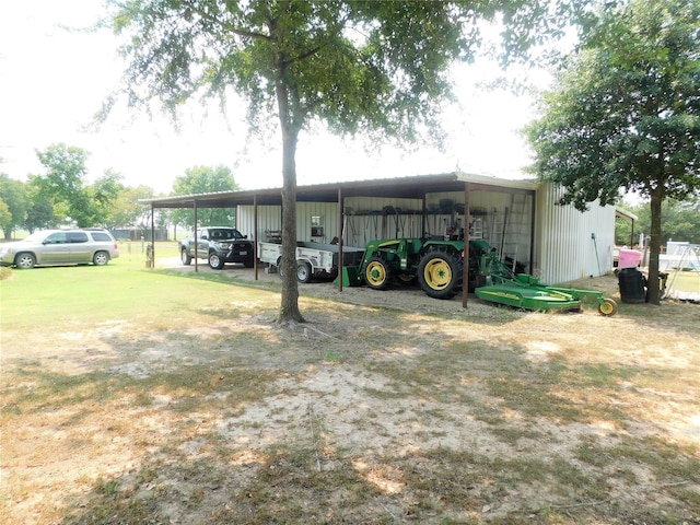 view of parking featuring a carport and a yard