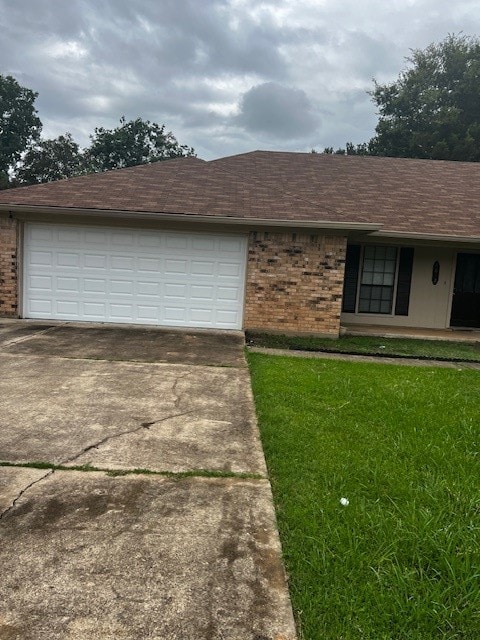 view of front of home featuring a garage and a front lawn