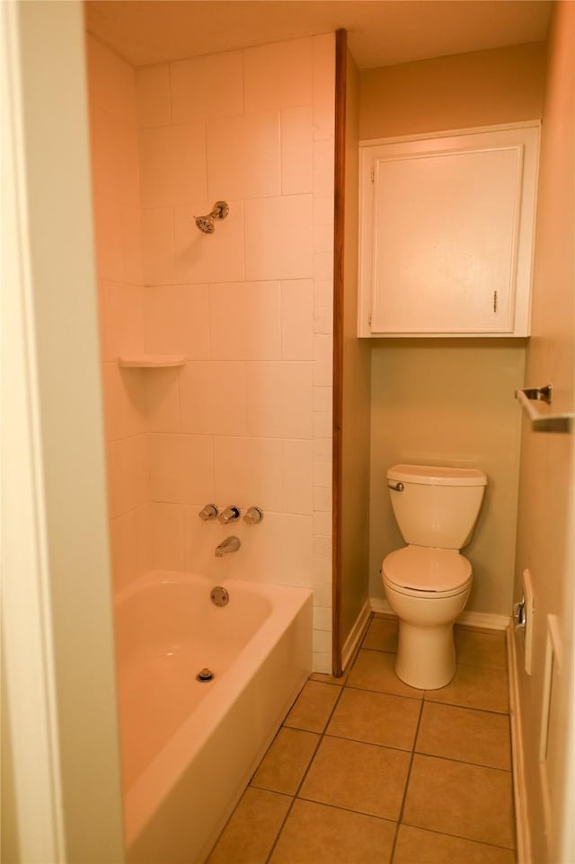 bathroom featuring baseboards, tub / shower combination, toilet, and tile patterned floors