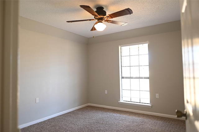 carpeted spare room featuring a textured ceiling, ceiling fan, baseboards, and a healthy amount of sunlight