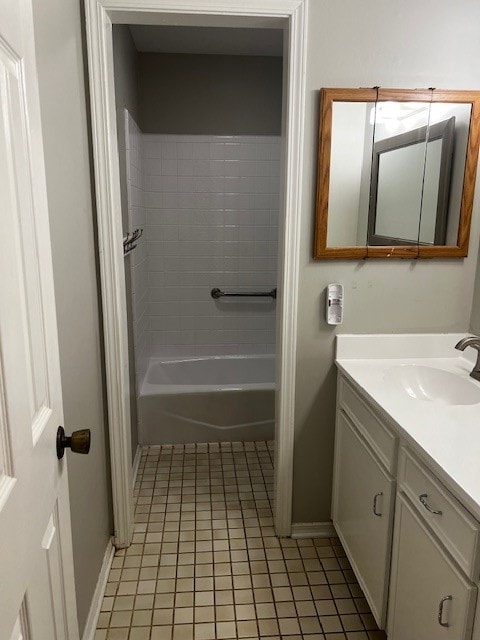 bathroom with tile patterned flooring, vanity, and tiled shower / bath