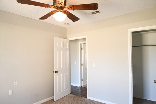 spacious closet with dark tile patterned floors