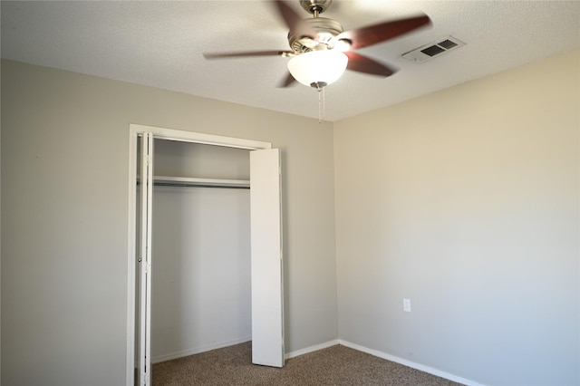 unfurnished bedroom featuring baseboards, visible vents, a textured ceiling, and carpet flooring