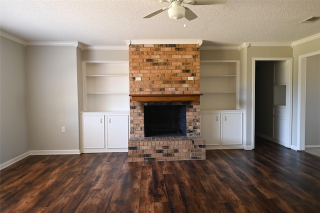 unfurnished living room with dark wood-style floors, a brick fireplace, visible vents, and a textured ceiling