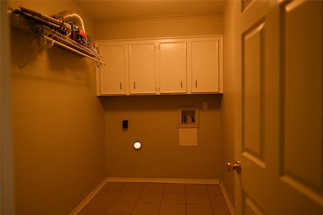 laundry area with cabinet space, baseboards, tile patterned flooring, washer hookup, and electric dryer hookup