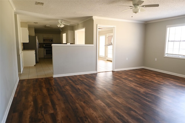 unfurnished living room featuring ceiling fan, a textured ceiling, wood finished floors, visible vents, and ornamental molding