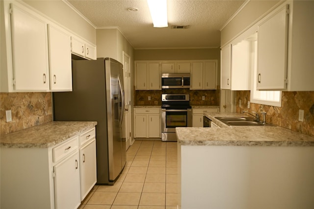 kitchen featuring light tile patterned flooring, a sink, visible vents, ornamental molding, and appliances with stainless steel finishes