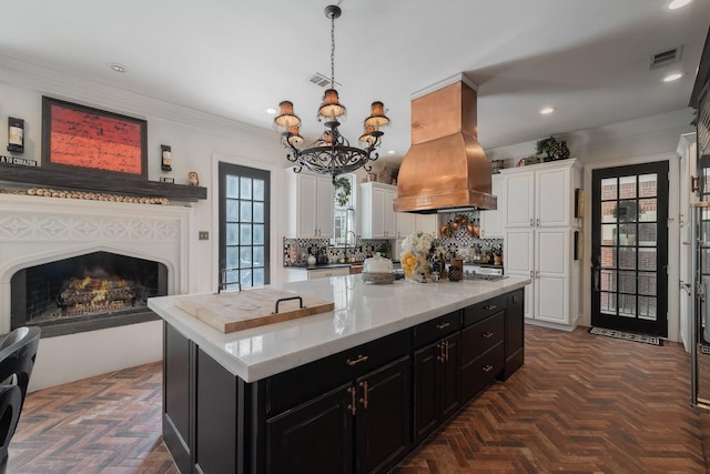 kitchen with white cabinets, dark parquet floors, and a kitchen island