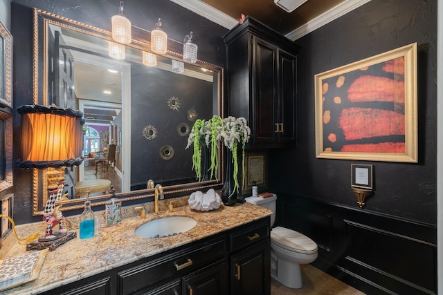 bathroom with tile patterned floors, toilet, vanity, and ornamental molding