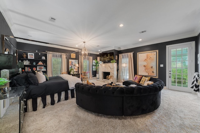 living room featuring carpet floors, ornamental molding, a high end fireplace, and a chandelier