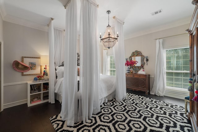 bedroom with an inviting chandelier, dark wood-type flooring, crown molding, and multiple windows