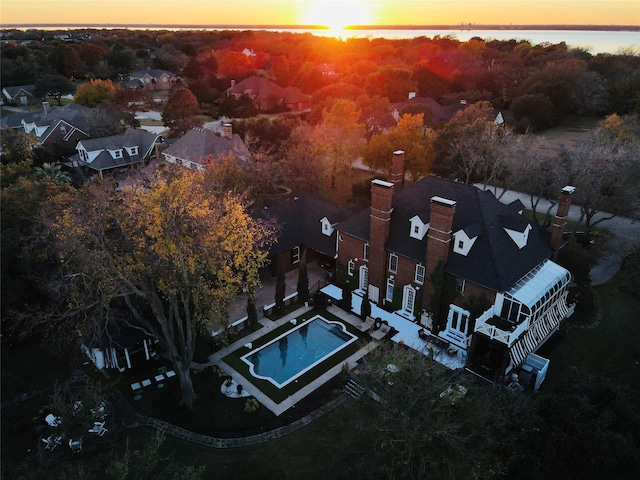 aerial view at dusk with a water view