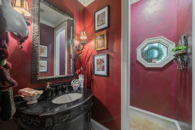 bathroom with tile patterned floors, crown molding, and vanity