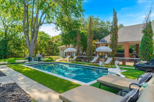 view of pool featuring a yard and a patio