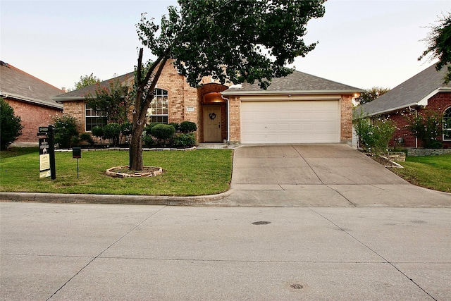 view of front of home featuring a front lawn and a garage