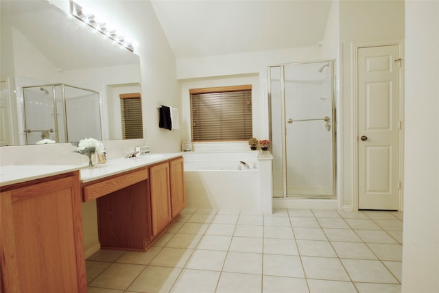 bathroom with tile patterned flooring, vanity, vaulted ceiling, and shower with separate bathtub