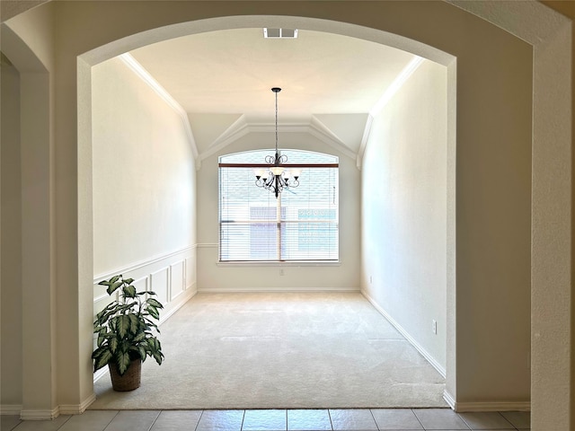 unfurnished dining area featuring light colored carpet, ornamental molding, a notable chandelier, and lofted ceiling