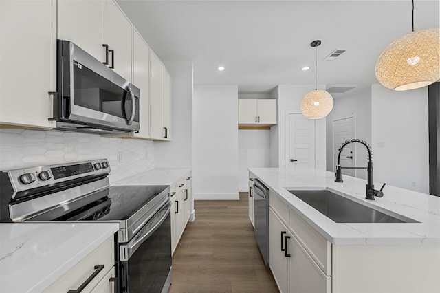 kitchen with white cabinetry, appliances with stainless steel finishes, hanging light fixtures, and sink