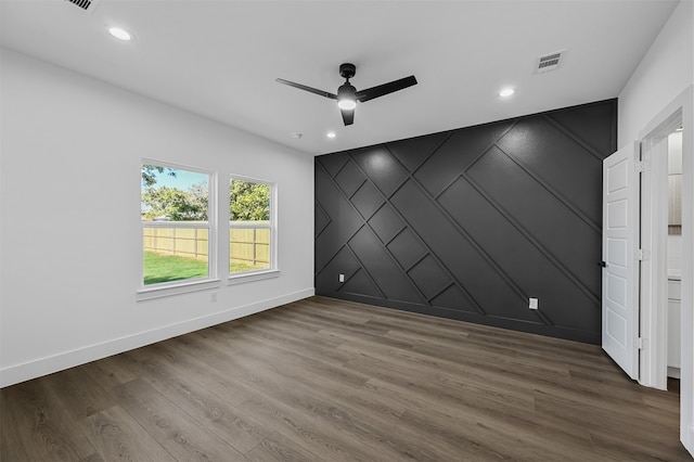 empty room featuring ceiling fan and hardwood / wood-style floors