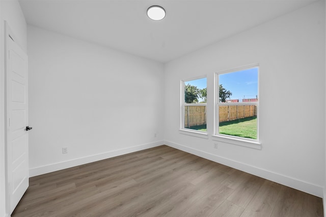 empty room with hardwood / wood-style flooring