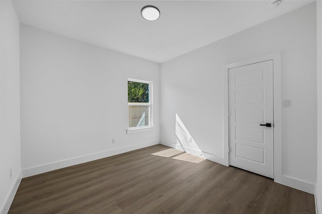 spare room featuring dark hardwood / wood-style floors