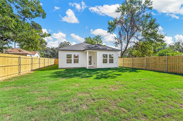 back of house with a yard